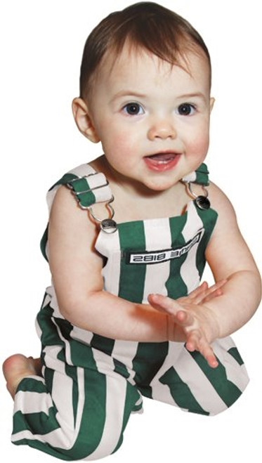 Infant wearing green and white striped cotton overalls, smiling at a tailgate gathering.