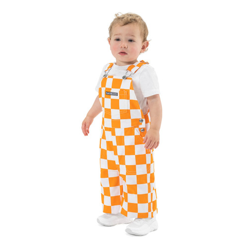 Infant Tennessee orange and white checkered Game Bibs bib overalls for Vols fans featuring a checkerboard pattern and a center chest pocket with the brand logo.