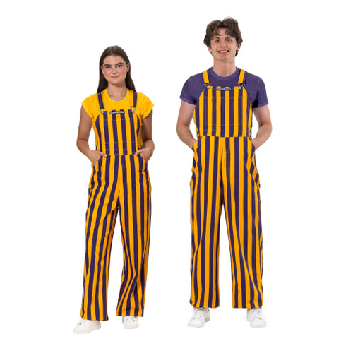 A man and woman wearing purple & yellow gold striped game day bib overalls.