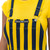 Navy blue and maize striped overalls chest detail, premium sports fan apparel.