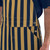 Branded two-button side closure on navy blue and gold striped overalls for sports fans.
