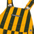 Close-up of green and yellow striped infant Game Bibs overalls showing the front bib pocket, Game Bibs logo and metal strap buckles.