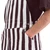 Highlight of the two-button side closure on maroon and white striped game bibs.