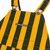 Close-up of green and yellow toddler Game Bibs bib overalls with front pocket, logo and metal shoulder buckles.