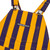 Close-up of purple and yellow toddler Game Bibs overalls with front bib pocket, Game Bibs logo and metal shoulder buckles.