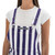 Close-up of the front chest pocket on purple and white striped overalls with logo.