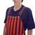 Detailed view of the chest pocket and logo patch on purple and orange striped game bibs.