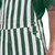 Side pocket detail on green and white striped game bibs featuring exactly two buttons.