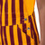 Side detail of maroon and gold striped game bibs highlighting the two-button closure.