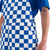 Side waist pocket detail on royal blue and white checkered game bibs featuring a two-button layout.