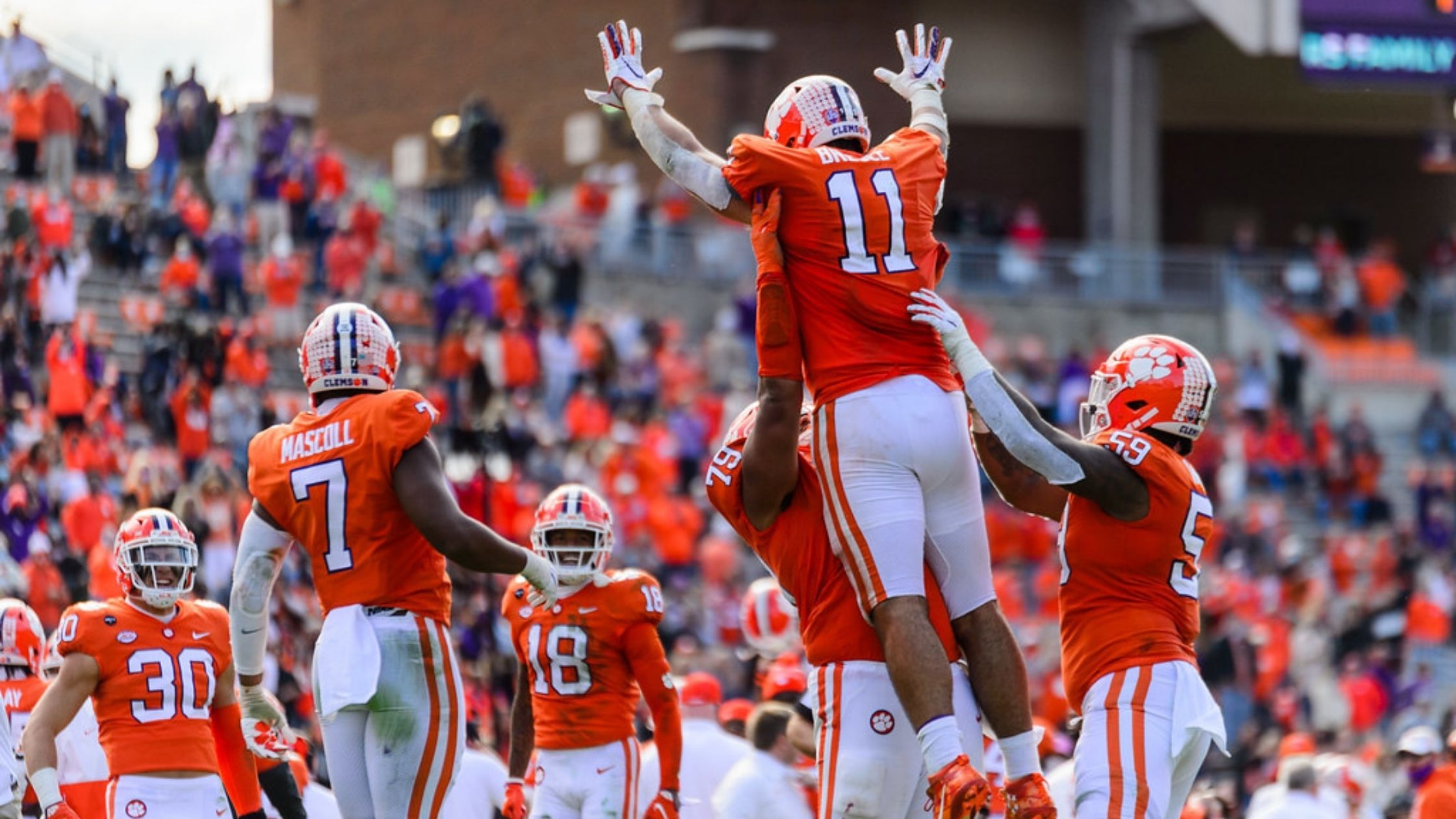 Clemson Tigers teammates celebrate a successful play against the Boston College Eagles in 2020.