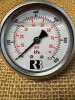 Closeup of the face of the centre back mount pressure gauge filled with glycerin