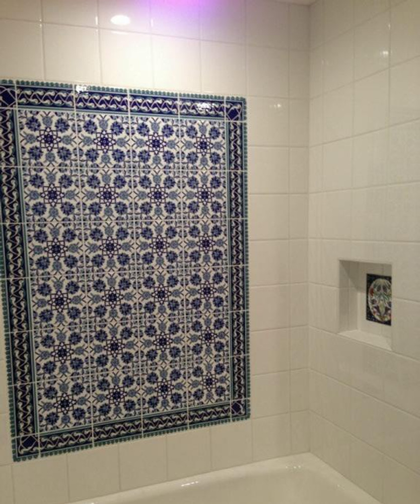 Rumi Border seen here in shower surrounding floral pattern wall tile