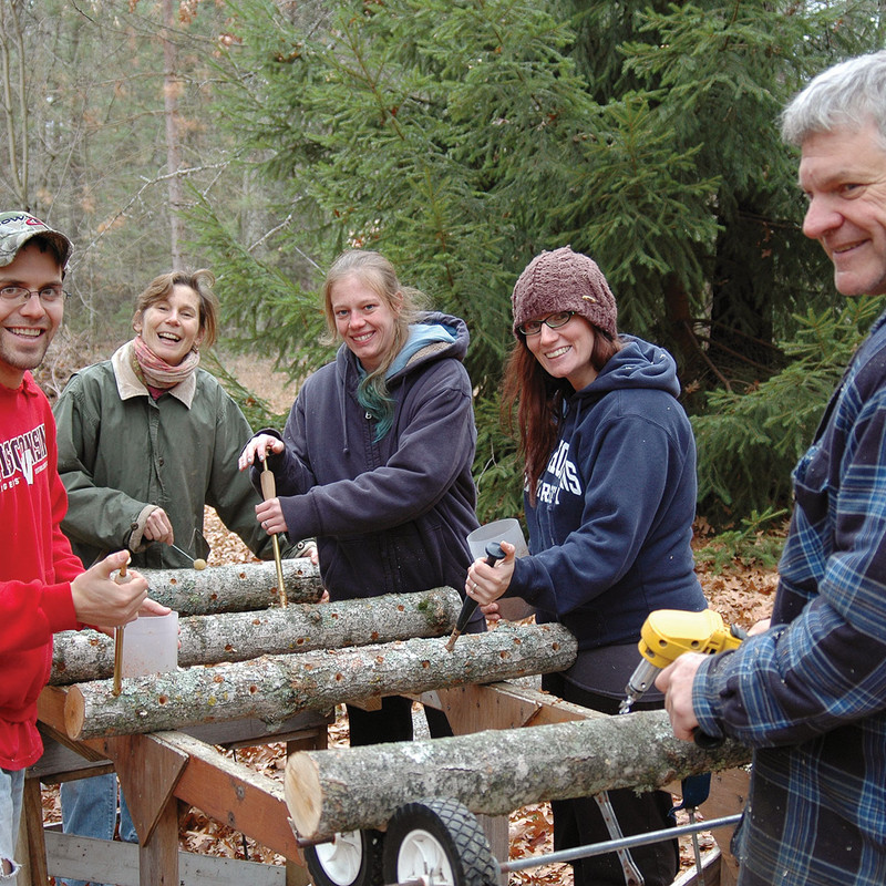Our team inoculating mushroom logs at the farm. Join our online seminar on March 17 to learn how to grow your own!