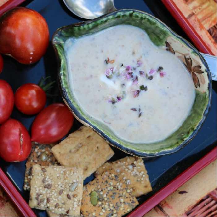 Cream of mushoom soup in a bowl with crackers. 