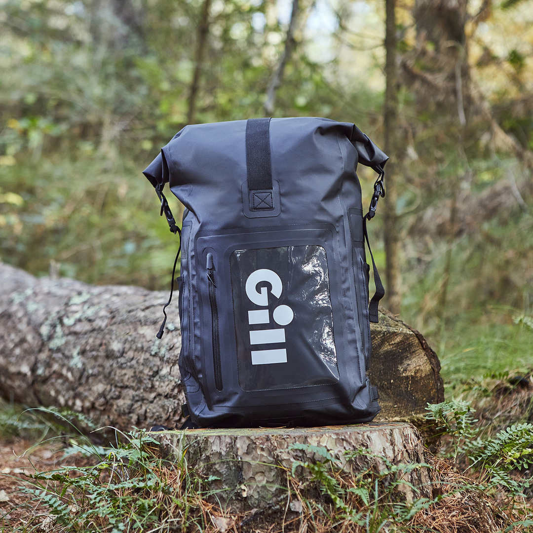 Gill Voyager Back Pack packed and stood upright on a tree stump