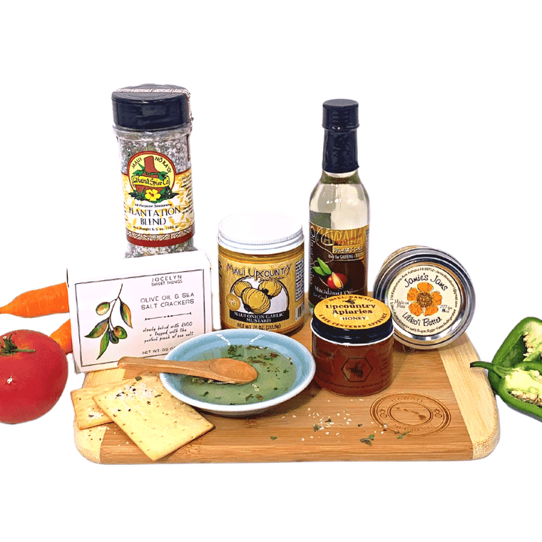 Hawaii bamboo cutting board with gourmet foods such as  Jamie's Jams lilikoi butter, Jocelyn & Co. Olive Oil & Sea Salt crackers, maui coffee roasters maui blend, macadamia nut oil, lahaina spice company lahaina burst, maui upcountry jams & jellies maui onion mustard, raw maui honey