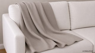 AI-generated simulation of taupe beige woven plain upholstery fabric draped across a cream sofa, showing fabric color, woven texture, and natural folds in a styled interior setting. The image is a digital visualization created from an actual fabric photograph and is intended to demonstrate color, pattern, and general appearance.