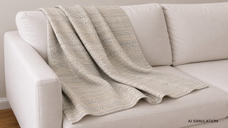 AI-simulated upholstery fabric visualization showing neutral textured woven fabric draped across an off-white sofa, illustrating fabric texture, weave detail, scale, and appearance in a residential furniture setting. The image is a digital visualization created from an actual fabric photograph and is intended to demonstrate color, pattern, and general appearance.