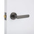 Installation of Manovella Fairhaven gunmetal privacy door lever handle with round rose for modern Australian homes.