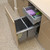 Modern kitchen pull out drawer half open in Australian home showcasing stainless steel storage solution.