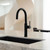 Modern Alia X51 matte black kitchen mixer tap with touch-sensitive controls for instant filtered boiling and chilled water on a kitchen sink in Australia.