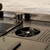 Modern stainless steel kitchen sink featuring an integrated glass rinser and soap dispenser for efficient cleaning in Australian homes.