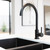 Meir Round Matte Black Gooseneck Kitchen Mixer Tap lifestyle shot in a modern Australian kitchen.