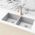 Meir MK03-CH Champagne Round Gooseneck Kitchen Mixer Tap installed with a double bowl stainless steel sink in a modern Australian home.