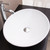 Top angle view of a white ceramic oval above countertop bathroom basin, Renovator Store Australia.
