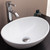 Angled view of a modern white oval ceramic vessel bathroom sink on a vanity, ideal for contemporary Australian homes.