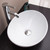 Top view of a white oval ceramic vessel bathroom sink on a wooden vanity, showcasing a minimalist above-counter design for modern Australian home renovations.
