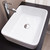 Top view of a modern white ceramic rectangular countertop bathroom basin with rounded corners, available for delivery across Australia.