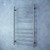 The Radiant RTR02 Round Bar Heated Towel Rail in Gun Metal Grey, measuring 600x1100mm, is a premium 10-bar stainless steel bathroom ladder available at Renovator Store in Australia.