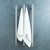 Radiant VTR-950 vertical heated towel rail in brushed satin finish with towels, 40 x 950mm stainless steel round bar for modern Australian bathrooms.