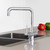 Modern chrome Puretec Tripla T5 three-way kitchen mixer tap installed on a white sink in a contemporary Australian kitchen.