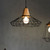 Industrial Black Metal Cage Pendant Light for Modern Kitchens and Dining Areas in Australia.