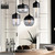 Modern Mara cylinder glass pendant light with matte black finish and clear glass shade, ideal for kitchen island lighting in Australian homes.