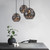 Lifestyle photo of three matte black adjustable height pendant lights illuminating a modern kitchen island in an Australian home.