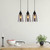 Lifestyle photo of a Jerez interior smoked glass pendant light illuminating a modern Australian dining area with a warm glow.