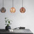 Modern matte black CLA Tuile series pendant light with embossed tile texture and geometric perforated holes for interior decorative lighting in Australian homes.