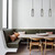 Lifestyle photo of the Pastille interior pendant light featuring a smokey black glass cylinder shade and satin chrome hardware, illuminating a modern Australian dining area.