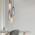 Modern Pastille glass pendant lights arranged in a cascade cluster, featuring smoked cylinder shades and satin chrome highlights for contemporary interior lighting in Australia.