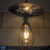 Vintage ST64 LED Edison light bulb with squirrel cage filament installed in a modern pendant light fixture for home decor in Australia.