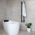 Modern matte black vertical heated towel rail installed in a contemporary Australian bathroom for space-saving luxury.