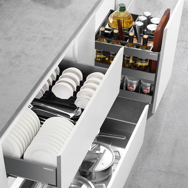 Organized pull-out kitchen drawer with grey inserts for cutlery and utensils in an Australian home.