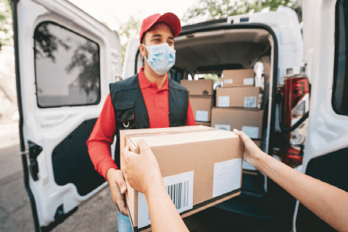 Courier loading boxes into van