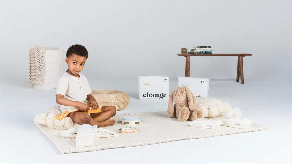 Toddler playing beside a change diaper box