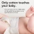 Close-up of a baby lying down wearing a natural, undyed cotton Change Diapers diaper. Text reads: "Only cotton touches your baby. Every layer against the skin is 100% cotton, with the world's first and only all-natural Super Absorbent core inside."