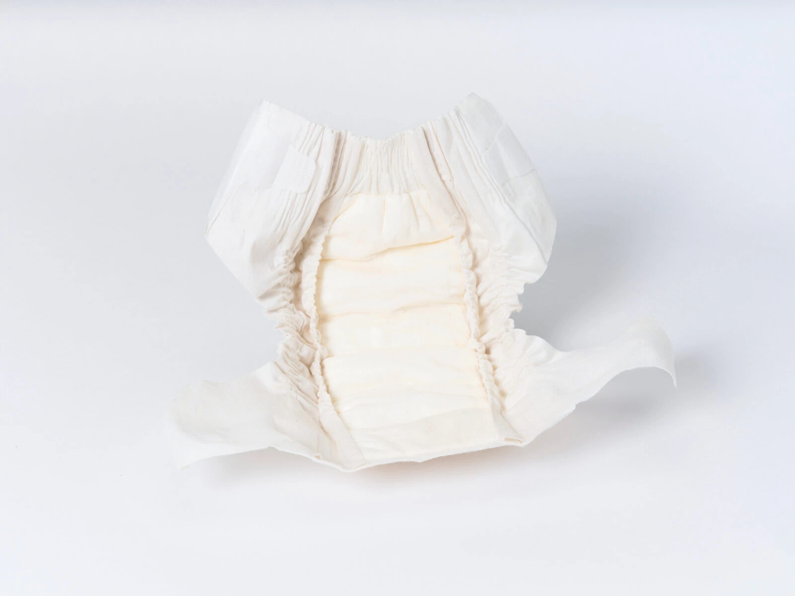 Open change diaper showing the cotton layers and absorbent core